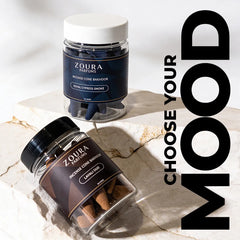 Two jars of Zoura Parfums incense cones on a marble surface with 'Choose Your Mood' text.