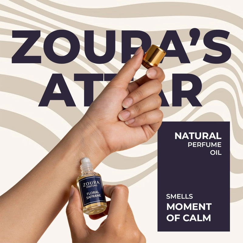 Zoura's Atelier natural perfume oil with a hand holding a bottle against a patterned background