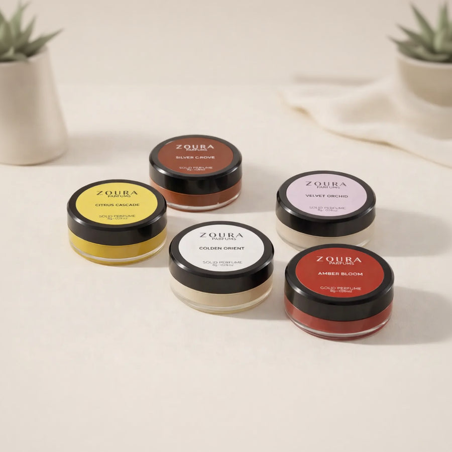 Set of Zoura cosmetic jars with colorful lids on a light background