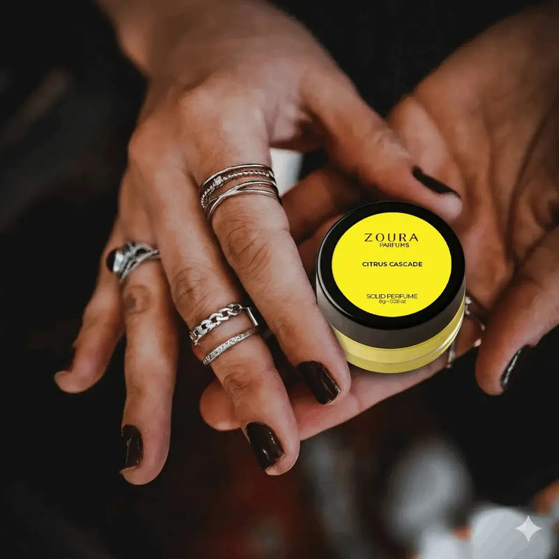 Woman holding Zoura Citrus Cascade Solid Perfume jar