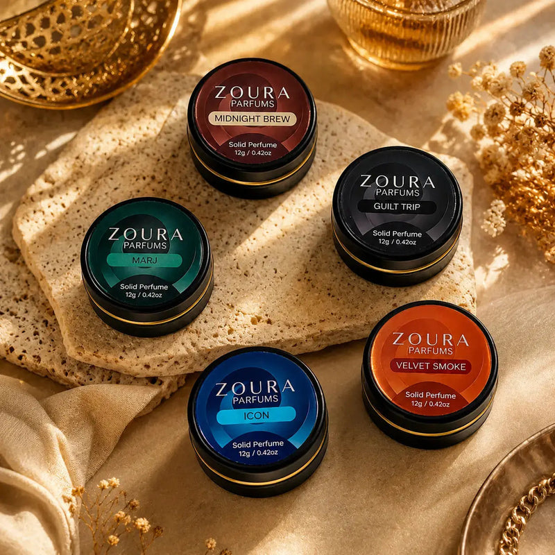 Zoura Parfums Elite Solid Perfume Collection on gold marble