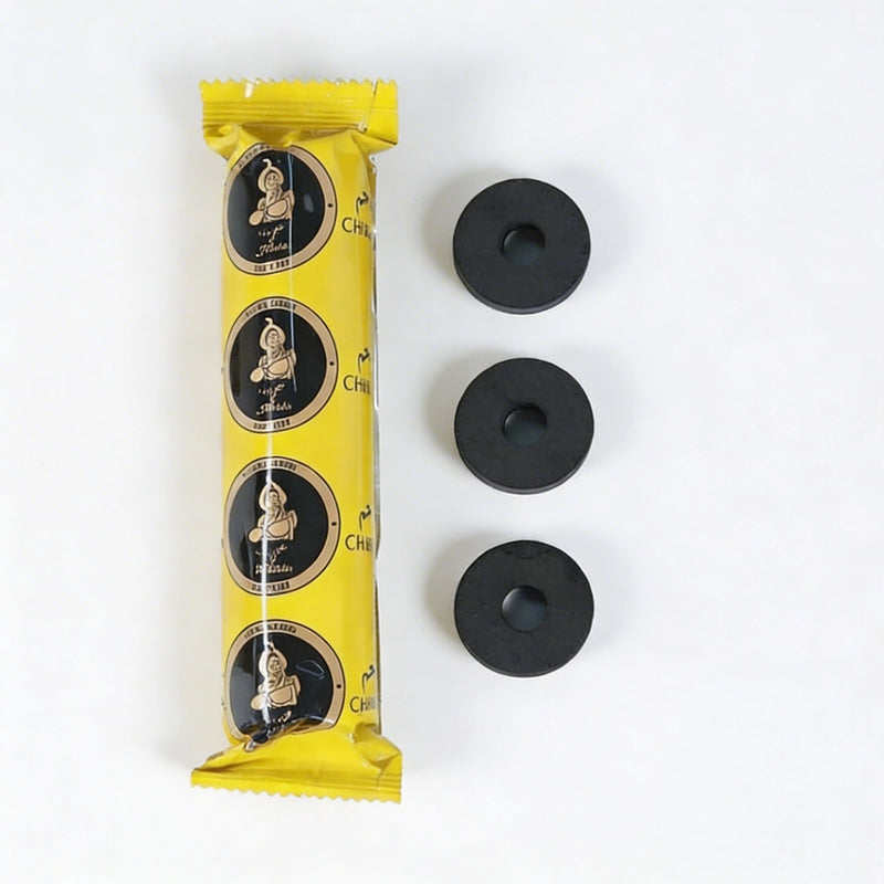 Yellow charcoal package with black circular items on a white background