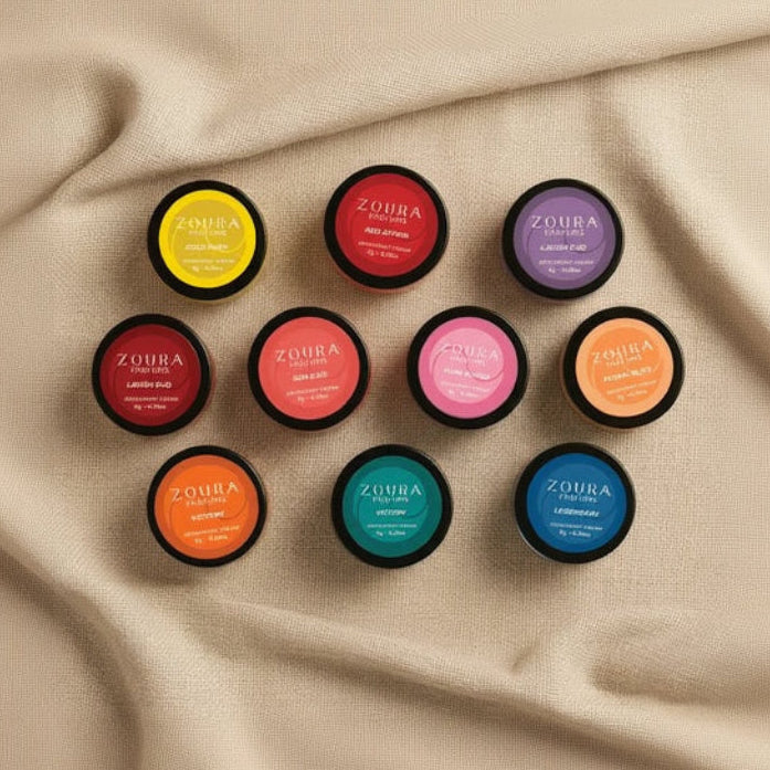 Collection of Zoura perfume bottles on a beige fabric background