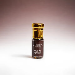 Zoura Perfume Attar bottle with gold cap on a gradient background