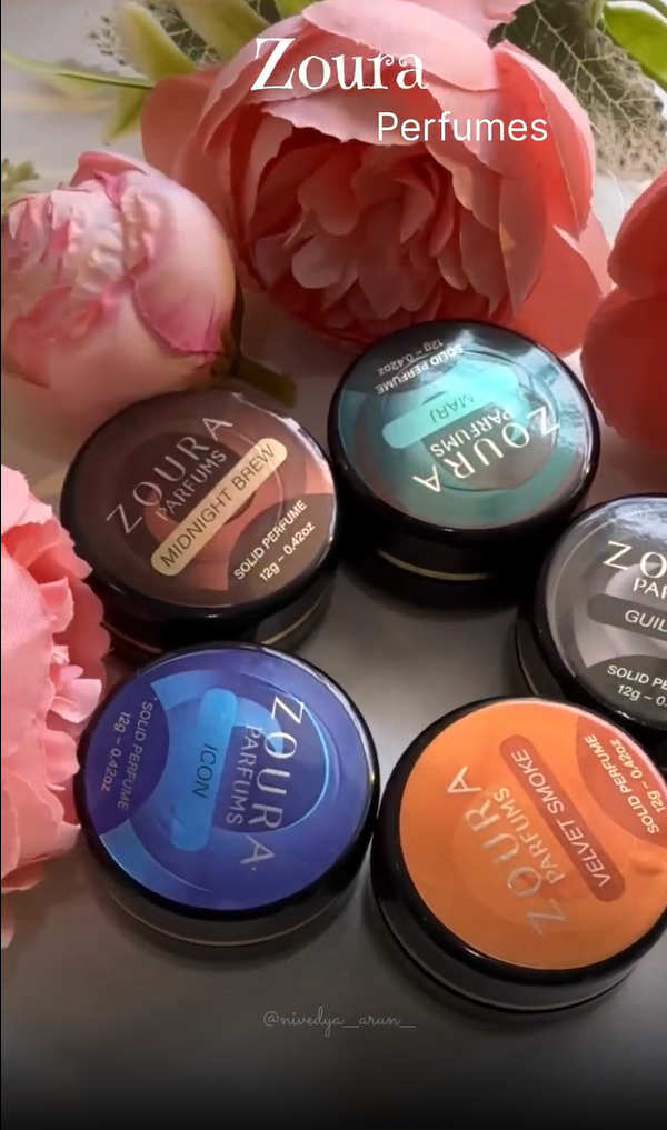 Zoura Parfums solid perfume 12g jars collection – Midnight Brew, Icon, Velvet Smoke and more, arranged with flowers