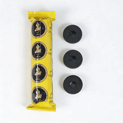 Yellow charcoal tablet package with round discs displayed on a white background