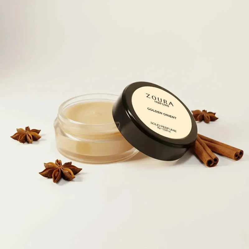 Open jar of Zoura Golden Orient Unisex Solid Perfume with star anise and cinnamon sticks