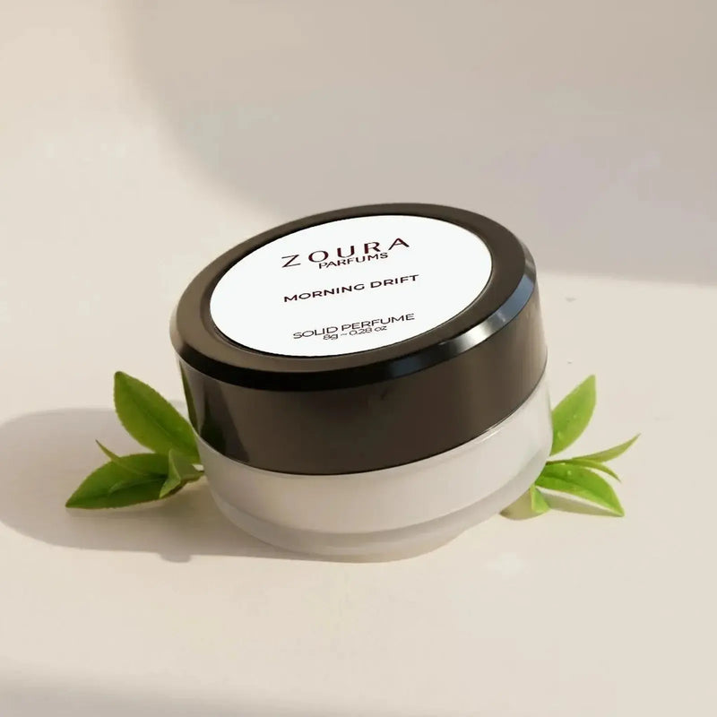 Zoura Morning Drift Unisex Solid Perfume jar with fresh green leaves, 8g