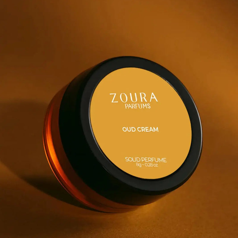 Zoura Oud Cream Luxury Unisex Solid Perfume jar on golden amber backdrop
