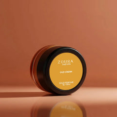 Zoura Oud Cream Luxury Unisex Solid Perfume jar with reflective warm background