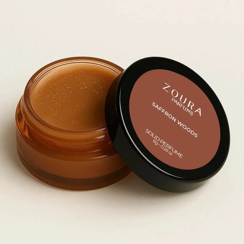 Open jar of Zoura Saffron Woods Luxury Fragrance Solid Perfume showing amber balm, 8g