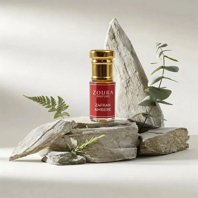 Zoura Zafran Amber Attar bottle styled with rocks and eucalyptus – unisex amber attar